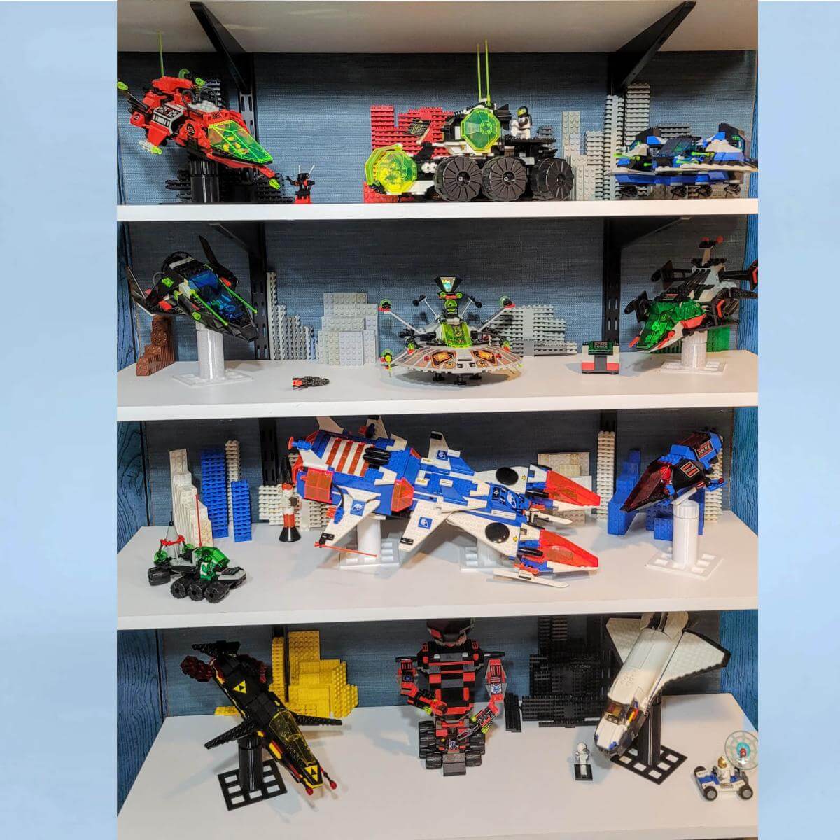 Dynamic LEGO display showcasing vintage space-themed sets from Blacktron, Space Police, Exploriens, and more, mounted on custom flight stands. Each spaceship is posed mid-flight on white or black risers, creating a dramatic action scene across shelves.