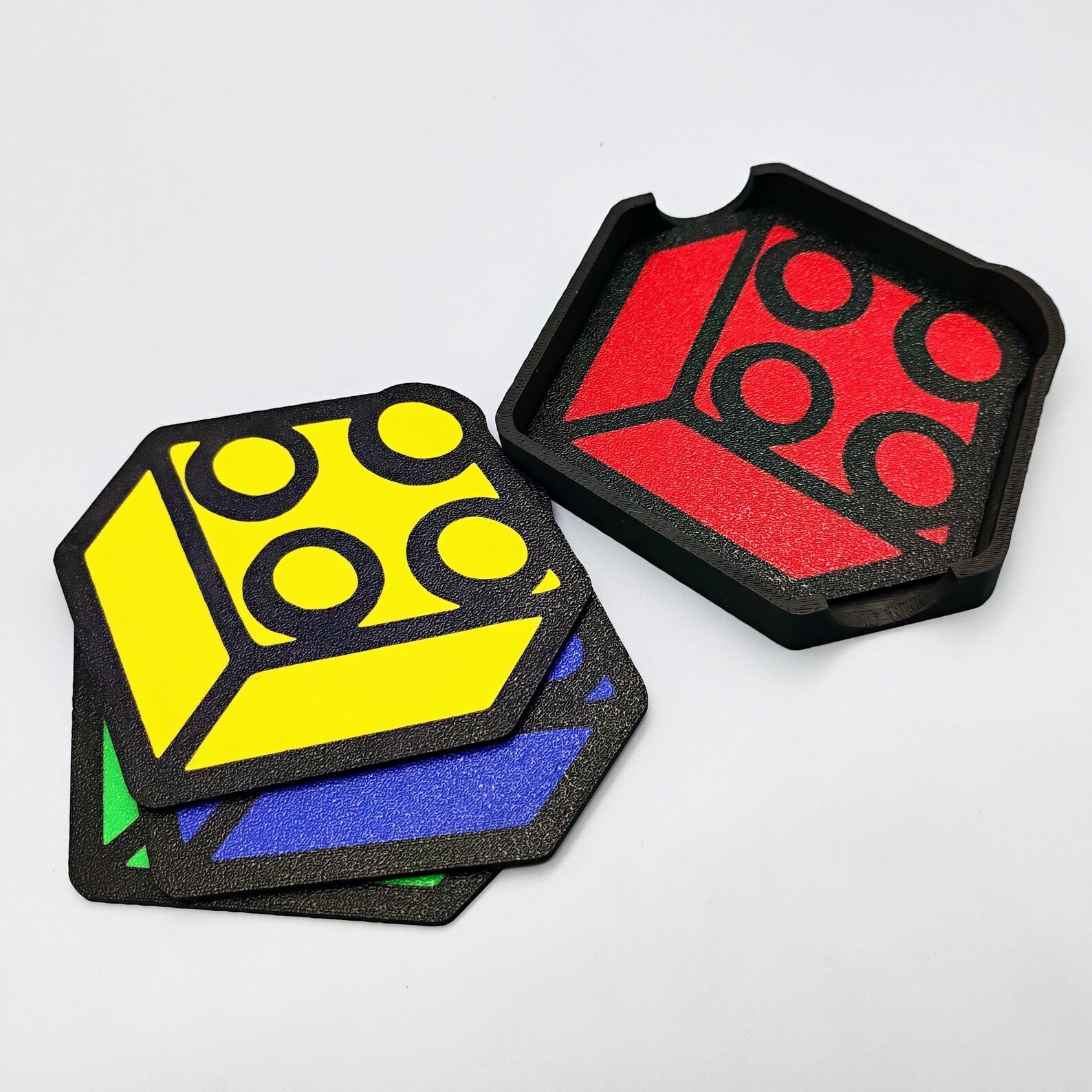 Angled view of brick-themed coaster set showing stud details and holder.