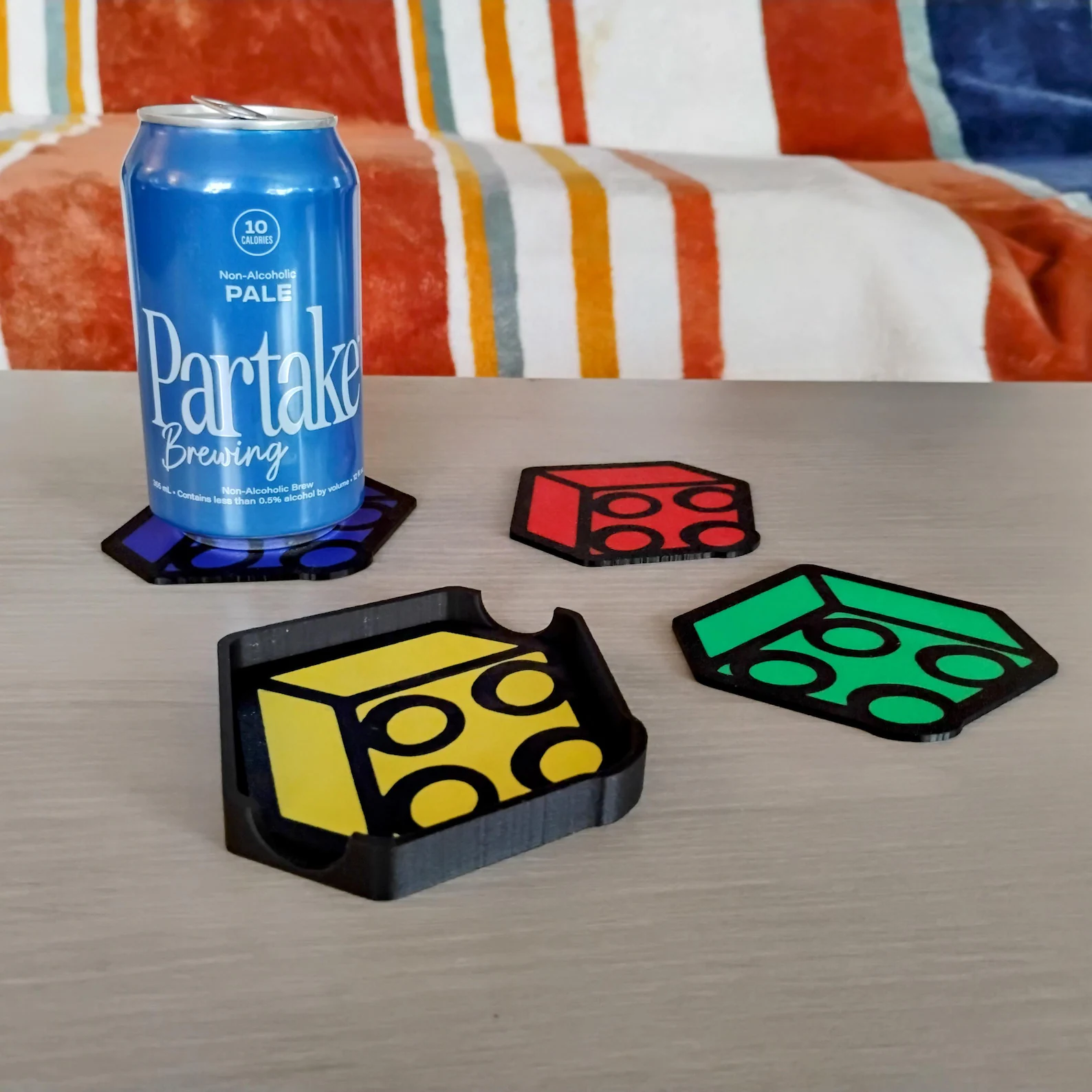 Brick-themed coaster set in use on a table holding a drink.