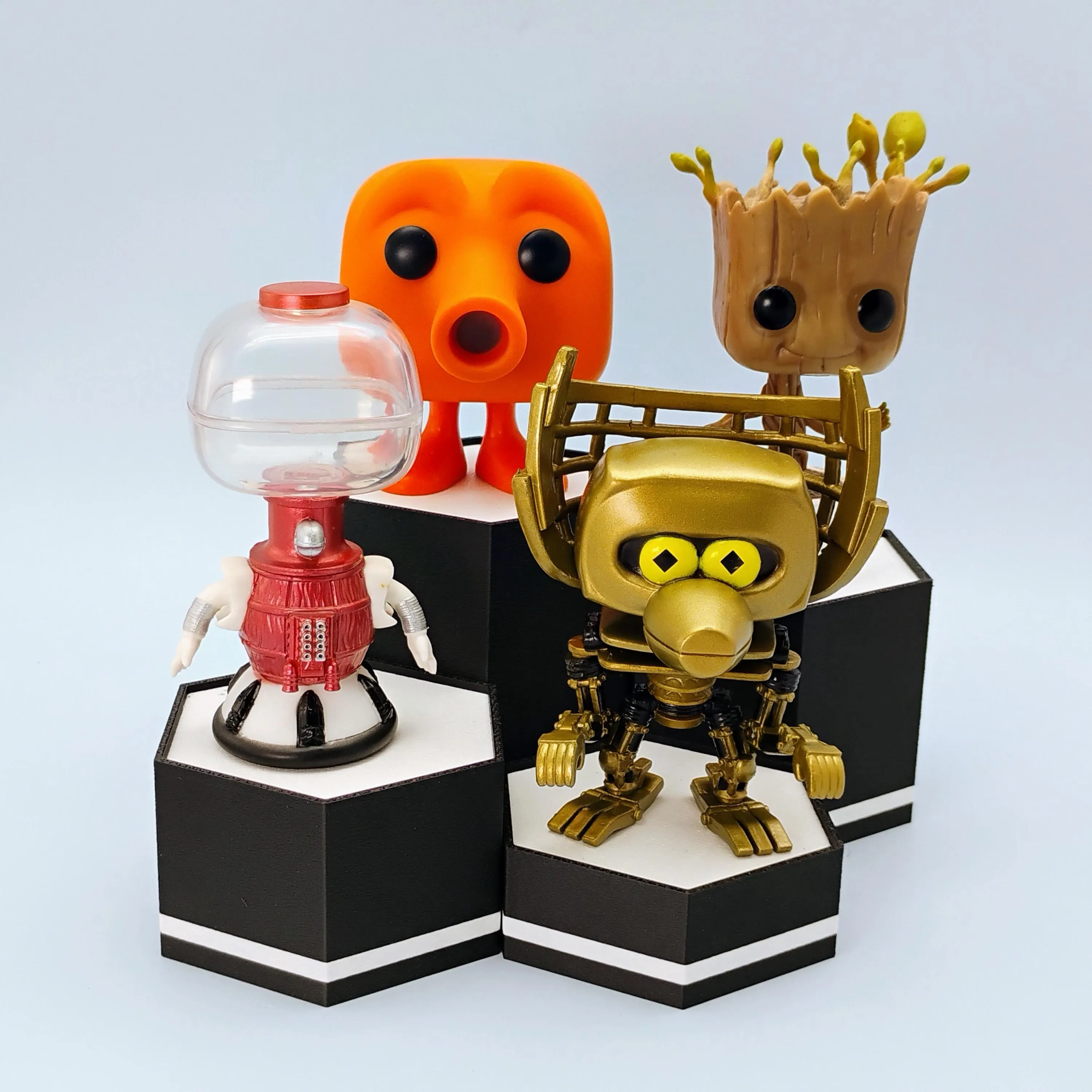 Funko Pop figures displayed on matte black hexagonal stands arranged in a clean modular layout.