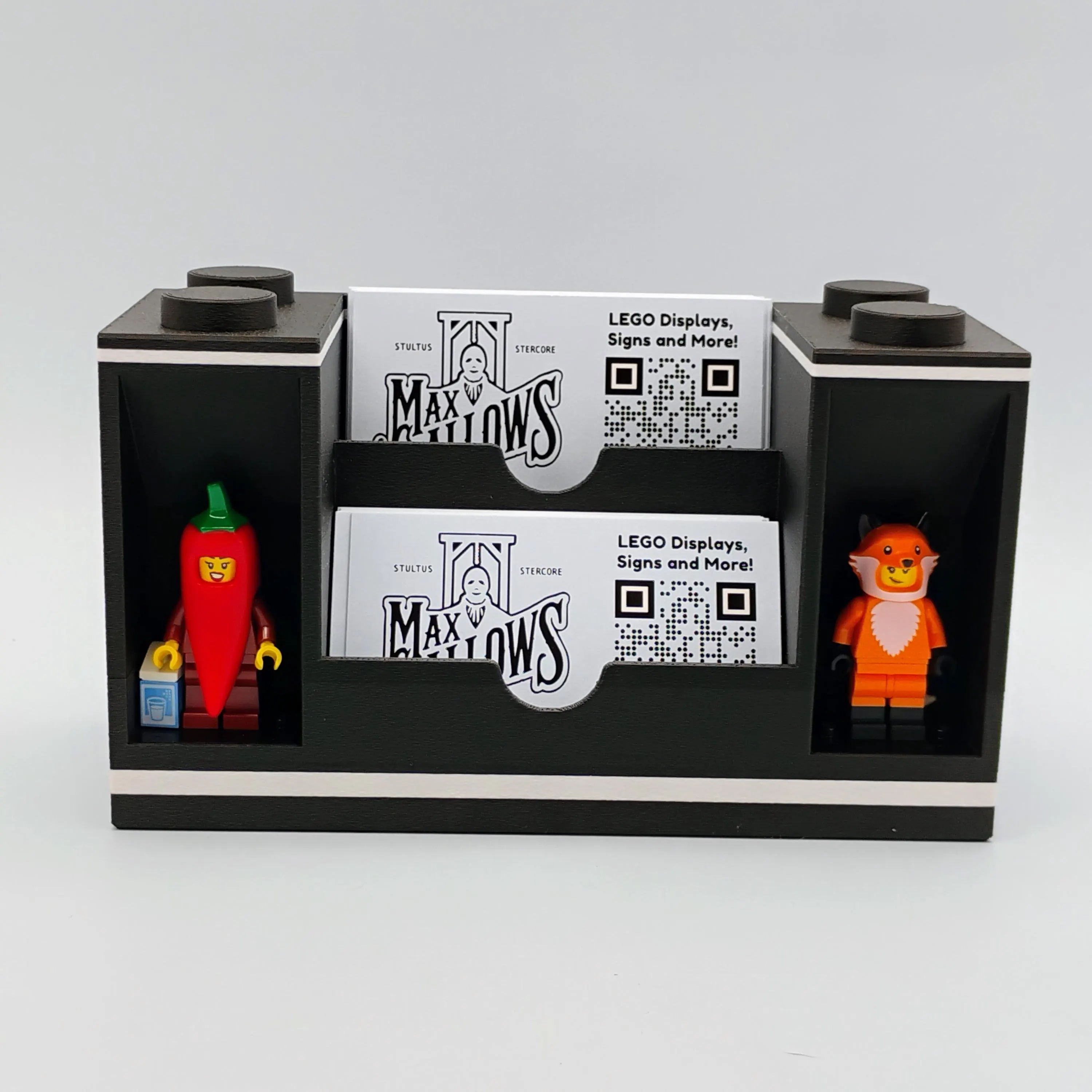 Dual-sided modular business card holder display with LEGO® minifigures on each end, designed as a bookend for desks or display shelves.