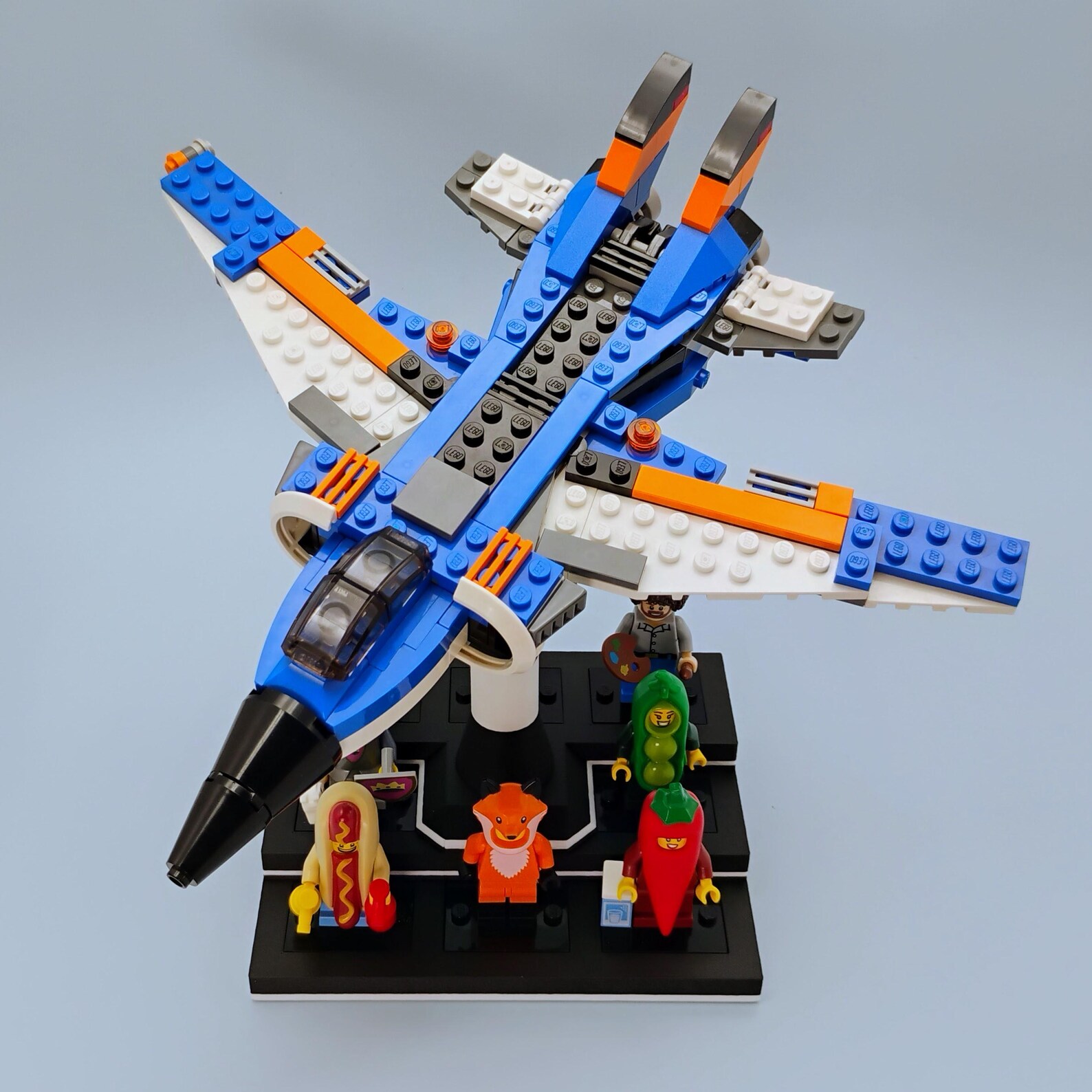 Angled view of the minifig display with ship stand showing the elevated ship pose and base footprint.