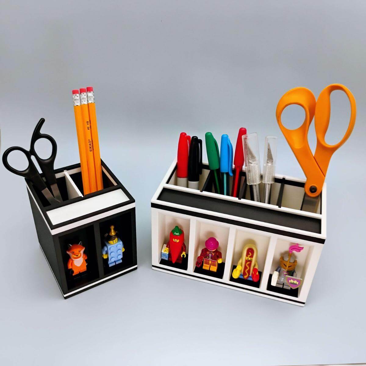 Top-down view of a LEGO-compatible pen and tool holder with customizable compartments and integrated minifigure display alcoves. Shows organization layout and removable dividers. A perfect workspace accessory for LEGO fans and desk warriors who like their creativity sorted.