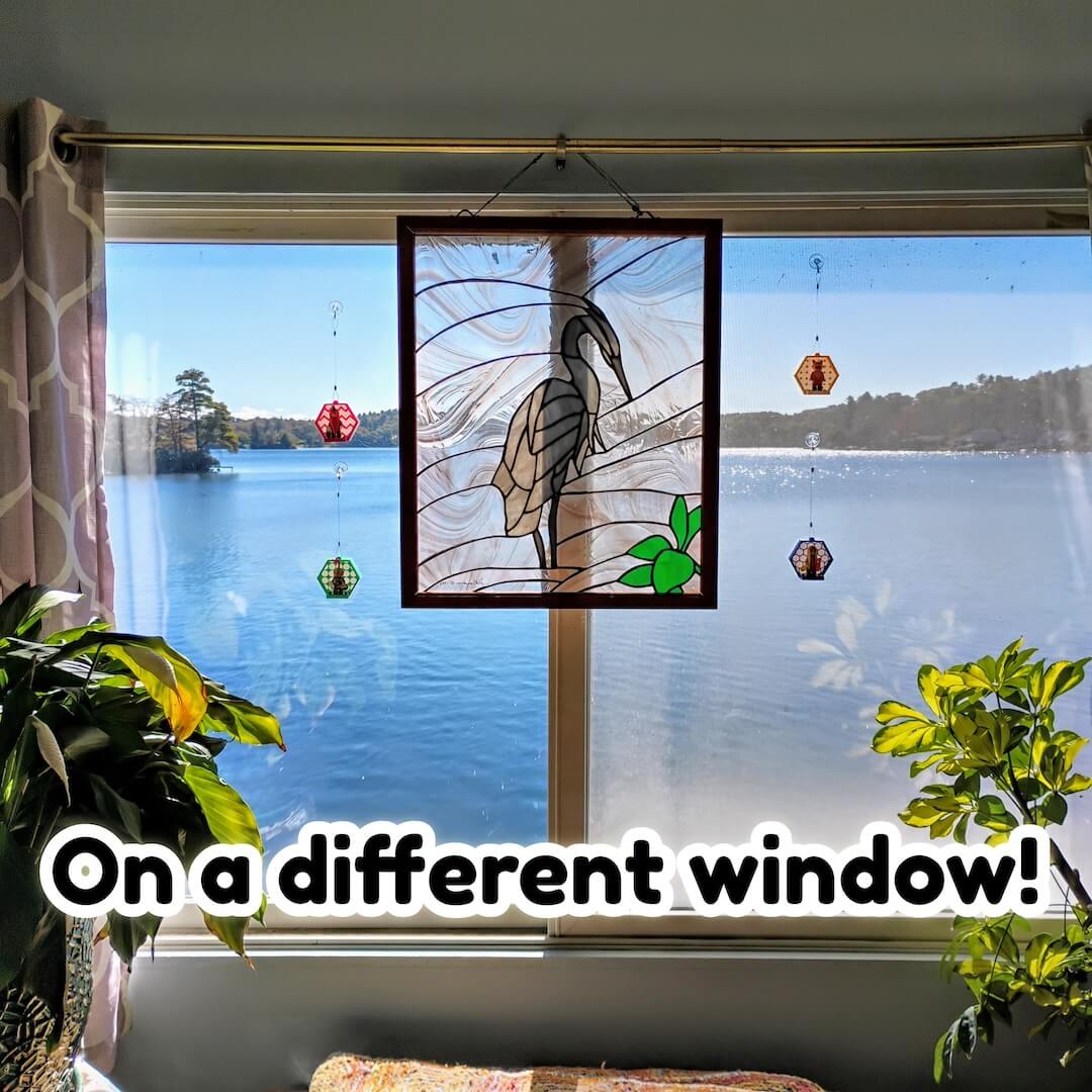 Multiple hexagon LEGO® minifigure displays on a wide lakeview window, each on a clear suction hook. Demonstrates how the system works on different windows and lighting conditions.
